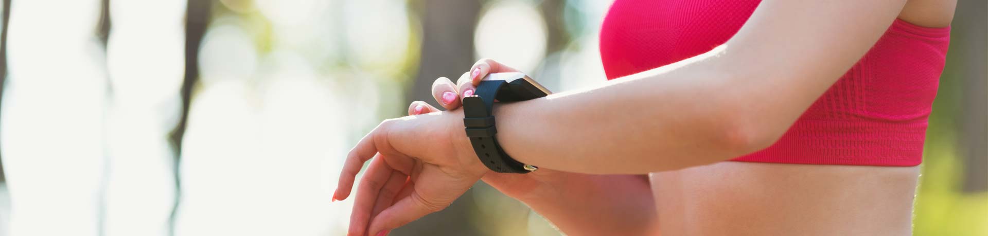 Female athlete using fitness app on her smart watch to monitor workout performance